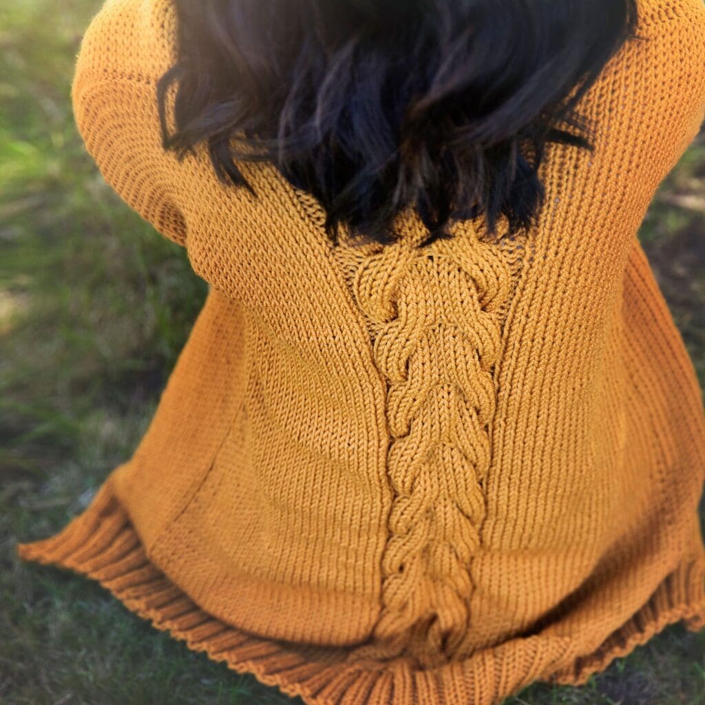 Orange knit cardigan on girl - free cardigan knitting pattern