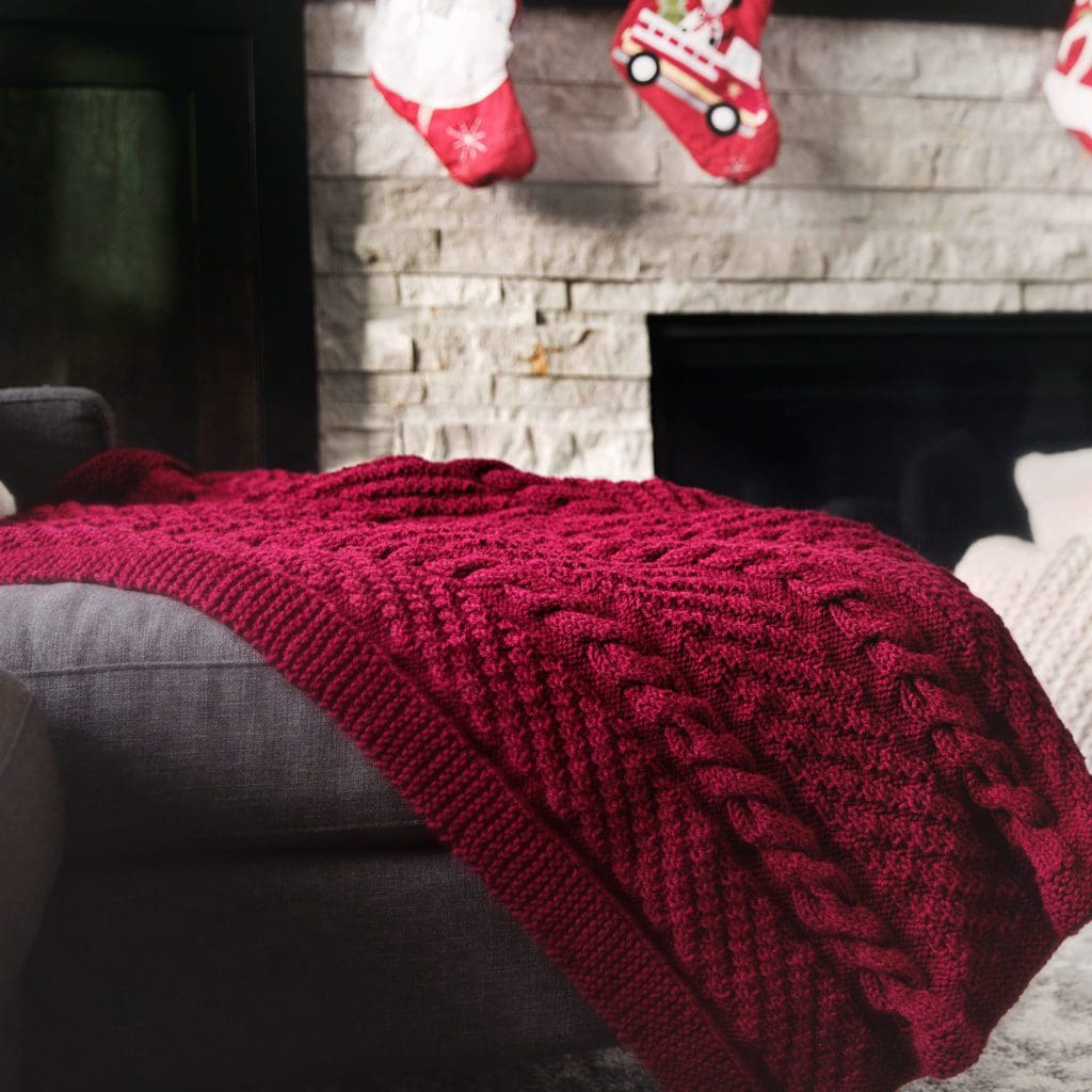 Cozy Cables Throw Blanket knitting pattern - photo of blanket on sofa